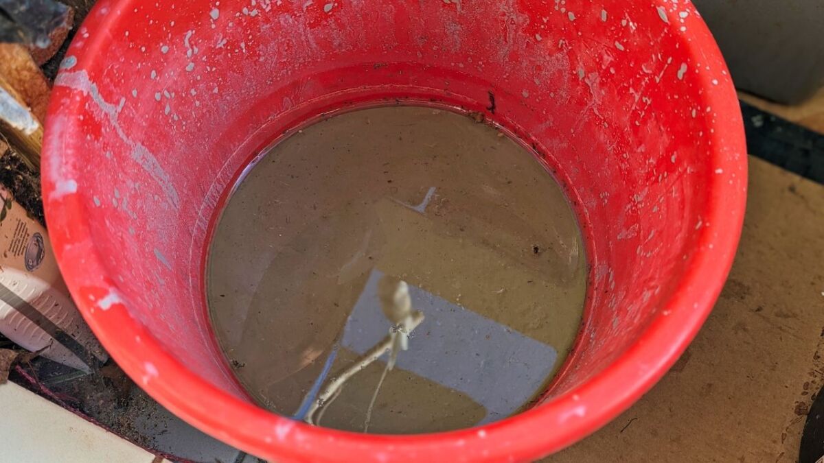 Let the bucket with the clay-water mixture stand still until water, clay and sand separate