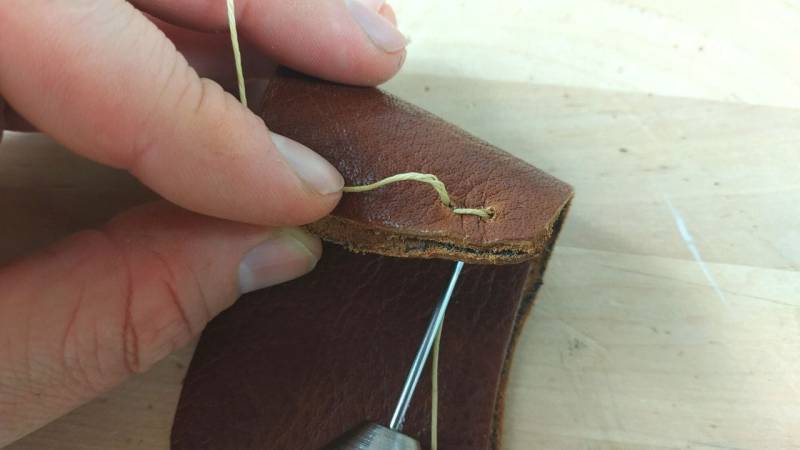 Pull the needle out of the hole and your stitch is finished
