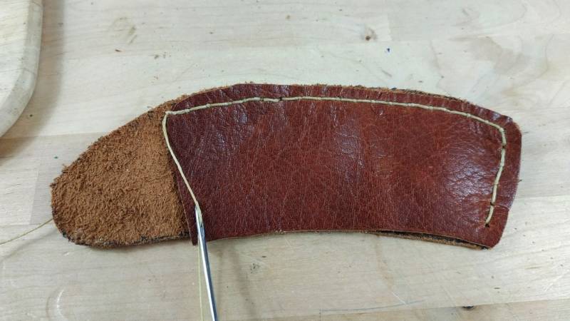 Keep going like this and in the end your axe leather sheath will be sewn together.
