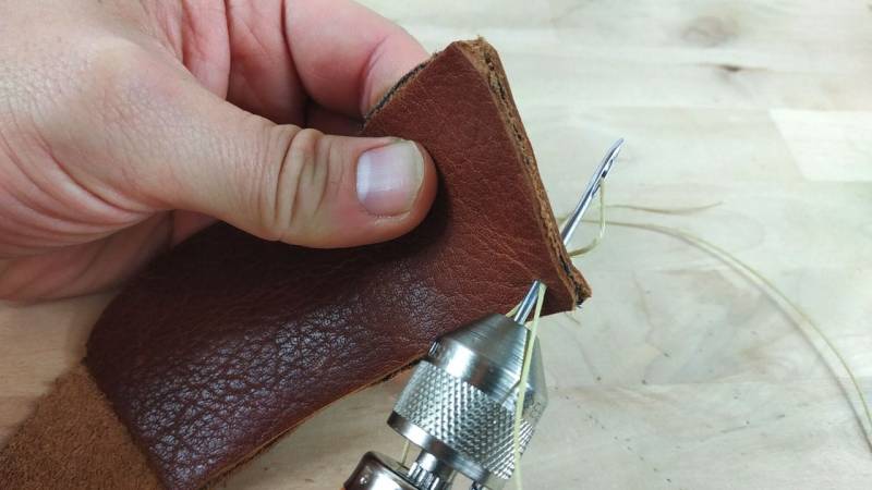 Start sewing by stitching through the leather at the bottom right.