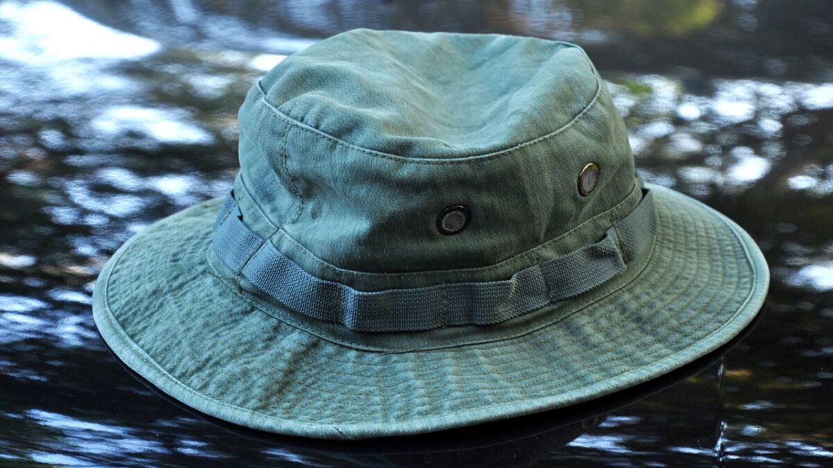 I myself like boonie hats, they are lightweight, provide good protection, and I can fold them to store them small