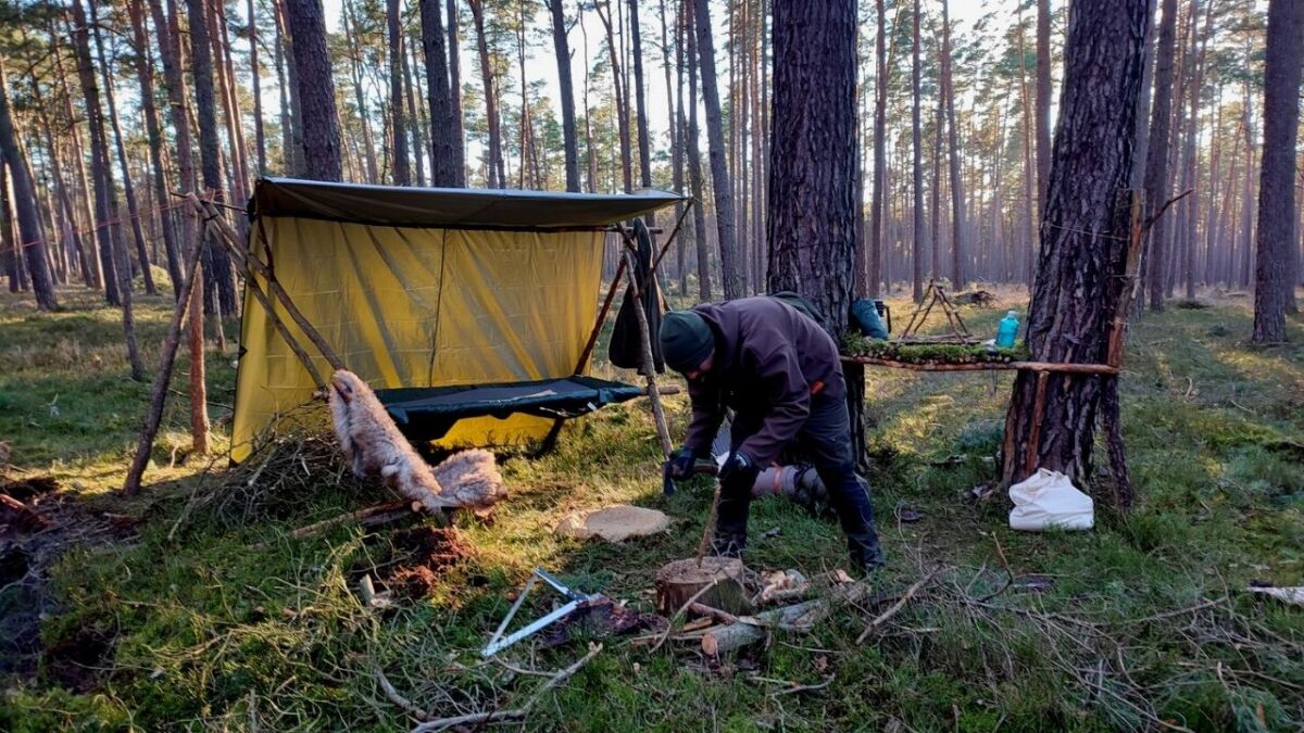 In summer as well as in winter, a tarp is a great way for a bushcrafter to protect their sleeping area from the elements