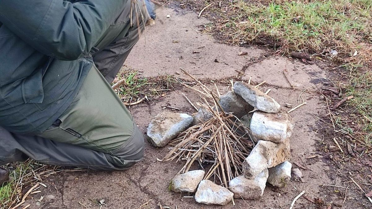 Bushcrafter kneeling down