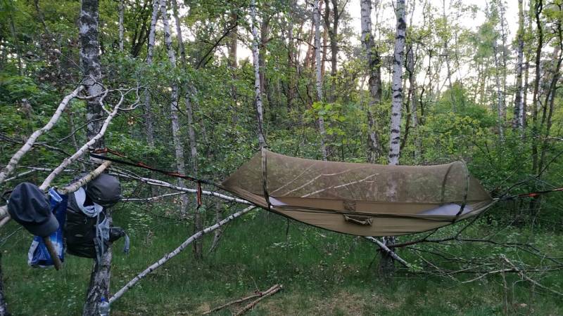 My sleeping spot with a hammock in good weather. The tarp comes over it when it rains and bad weather is on the way