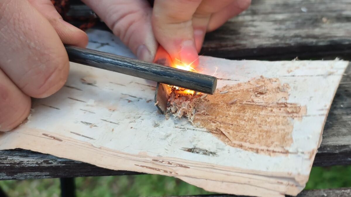 Someone using a Firesteel to make fire