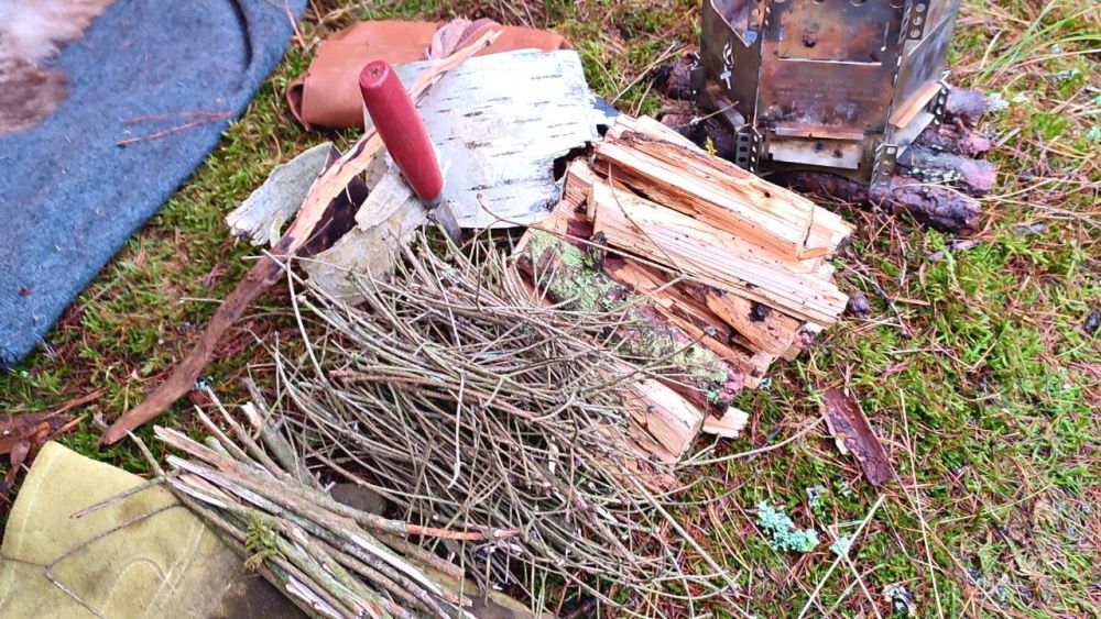 Someone preparing wood for a fire