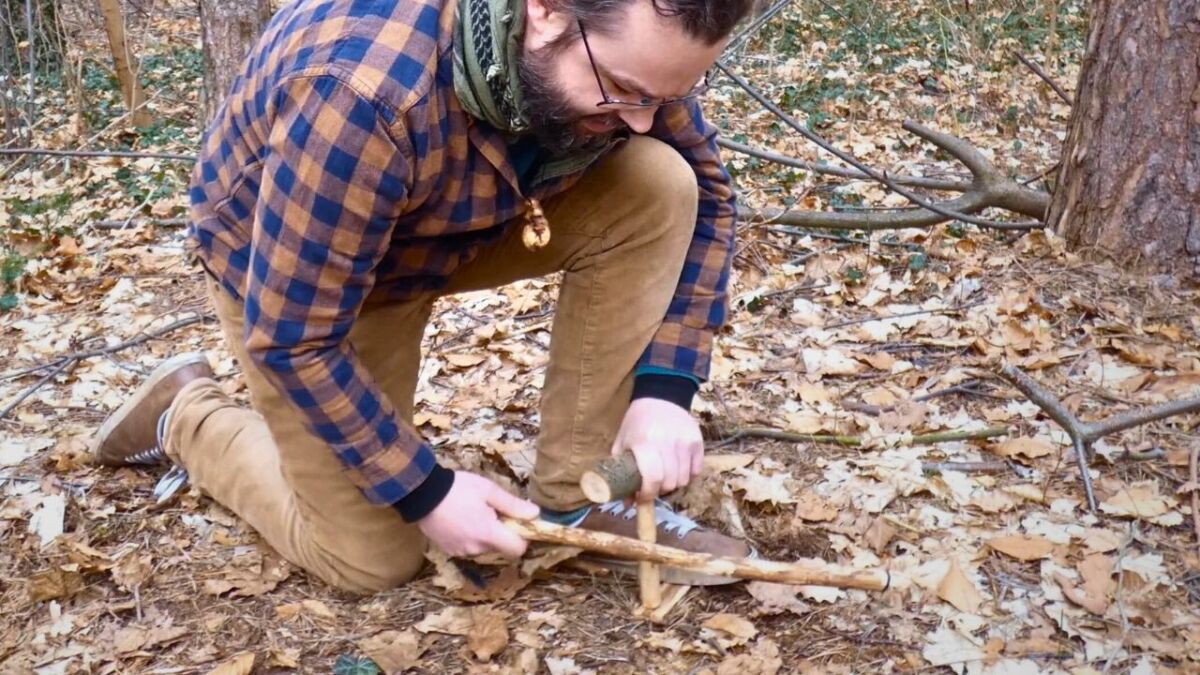 Making a fire with a bow drill