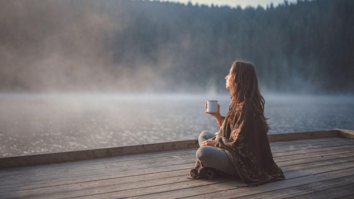 frau am see mit kaffee