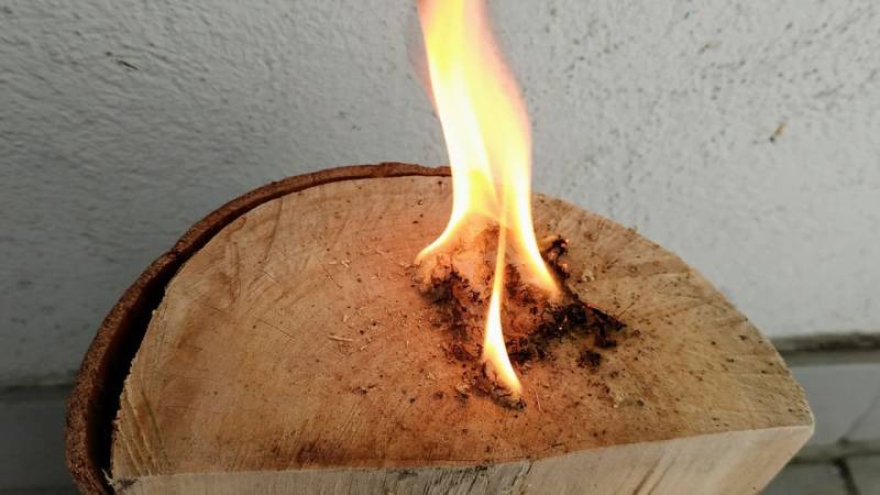 You ignite the pine torch wool tinder bundle with your fire starter