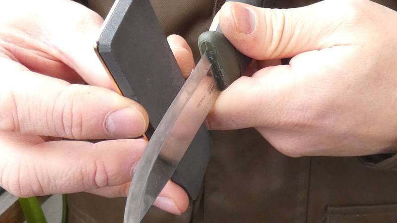 Knife being sharpened on a sharpening stone