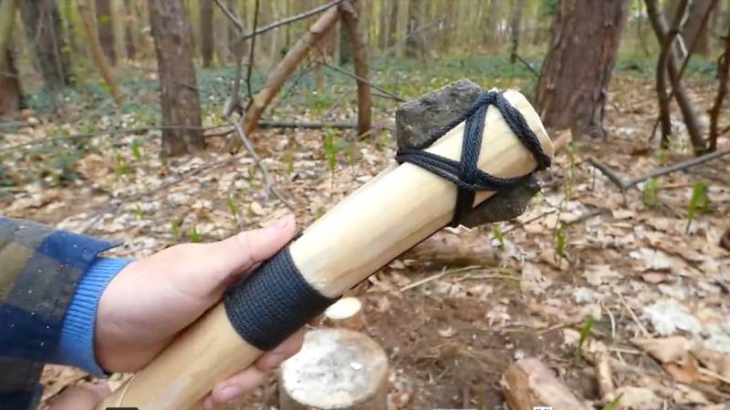 You can make a primitive stone axe with a stone, rope and a branch