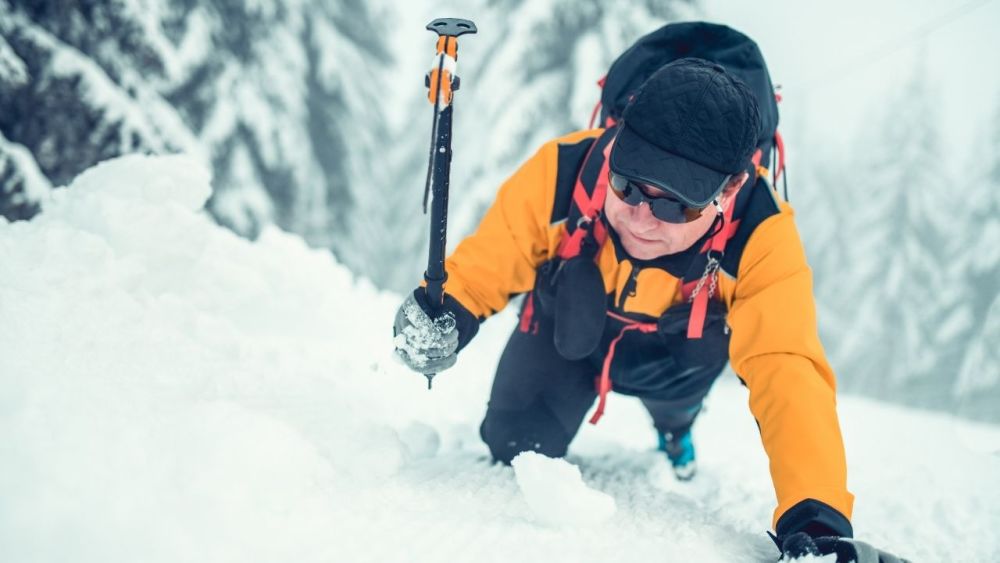 An ice axe is a tool used in mountaineering and climbing to provide traction when ascending steep slopes of snow or ice. It consists of a metal spike attached to a rigid shaft, with a handle mounted perpendicular to the shaft at the top.