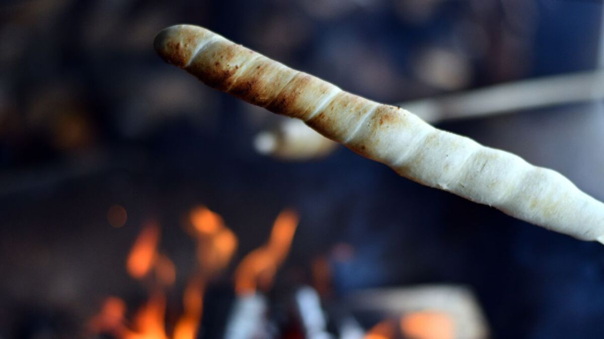 Image of stick bread being baked over the coals